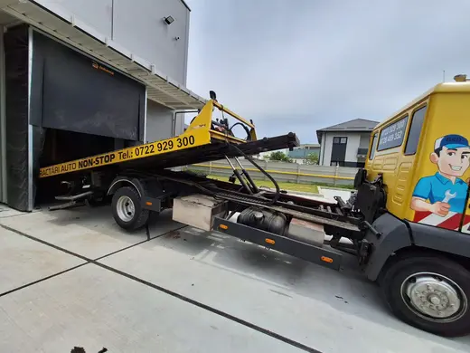 Utilaj industrial dezmembrat, încărcat pe platforma camionului de tractare